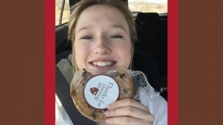 Eliza Maher holds a Saint Lawrence pub cookie. 