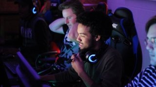 Students play esports in a dark room.