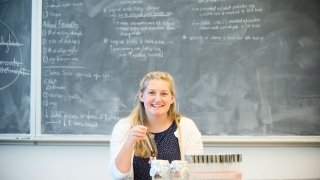 Katie Miller sits at a table with several samples.