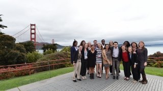 A group of Saint Lawrence students, attending a St. Lawrence University career connections event, stand in front of the Golden Gate bridge in California. 