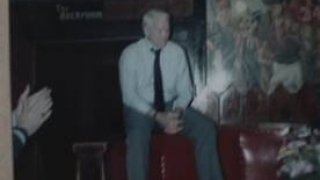 Don Leet sitting on ledge in dark room