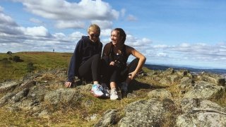 Two Saint Lawrence students sit on the ground in Edinburgh, Scotland. 