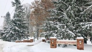 The Saint Lawrence University entrance sign on a snowy winter day. 