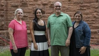 Laurie Olmstead, Ronnie Olesker, Ed Harcourt, and Erin Colvin stand together after receiving University awards.