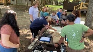 ADK Assistant Director Will pointing out the canoe expedition route