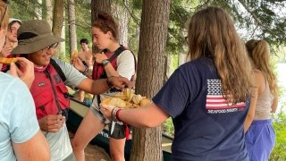ADK semester 2019 alum serving fresh melon to newly arrived students
