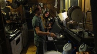 Roisin and John tackling the mound of dishes left behind at the end of day in Arcadia.