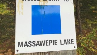 A trail marker indicating the canoe carry to Massawepie.