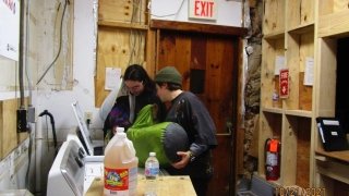 Cara and Bri deliberate on who can fit what into the washer.