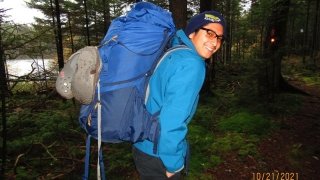 Robertson and his pack of laundry set out on the trek to the washing machine.