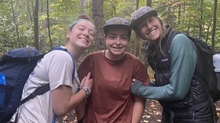 Sage and Ryann warming their hands with Cara’s body heat.