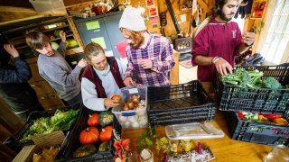 Saint Lawrence University students organize fresh produce in the kitchen during the Adirondack Semester.