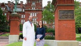 Morgan O'Hare stands outside of The Johns Hopkins Hospital with alumnus Doctor Robert Montgomery.