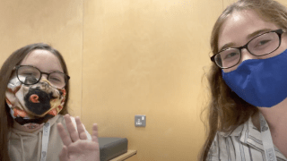 Elise Pierson, wearing a mask, speaks with Lilly Platt, a twelve year old environmentalist, also wearing a mask, about her plastic pick up project.