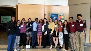 A group of Saint Lawrence University students, wearing professional attire, attend a CSTEP conference.