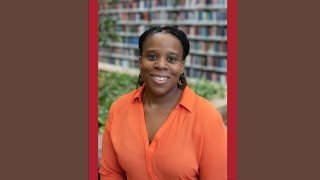 Headshot of Precious Hall on Red and Brown Background