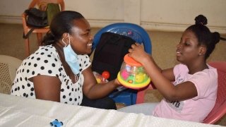 Adwoa Pokuaa Boateng works with a child as part of her Project for Peace, Cerebral Palsy Therapies on Wheels.