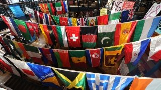 A photo of dozens of different countries' flags hanging up in the student center.