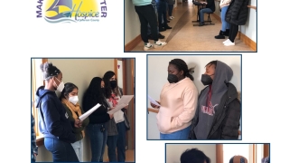 students lined in hall with woman playing keyboard and singing