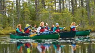 A photo of St Lawrence students canoeing on a lake. 