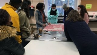 Artist Chloe Alexander welcomes some guests to the studio