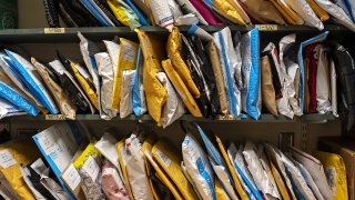 A photo of the mail center at St Lawrence with shelves full of envelopes.