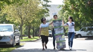 Family members helping a student move their stuff into the dorms