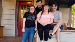 A photo of several Barista members on their house's front porch.