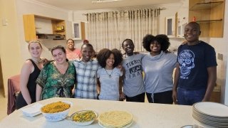 Students enjoying a meal with hosts