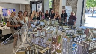 Students Stand in Front of Diorama Exhibit