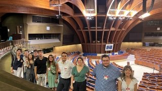 Students Gather in a Large Assembly Hall