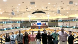 Students Stand in Large Assembly Hall