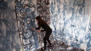 woman with large abstract multi-wall painting