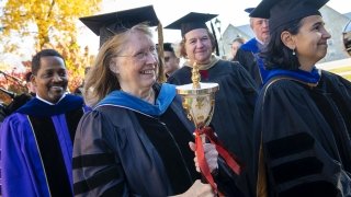 Patti Frazer Lock, Ana Estevez, Hagi Bradley, and Florence Hines, all wearing academic regalia, line up during the Presidential Inauguration Ceremony.
