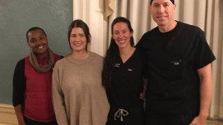 four physians posing for picture