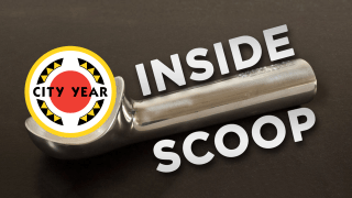 An ice cream scoop lays flat with the words "INSIDE SCOOP" flanking both sides of the handle. Inside the scoop is the City Year logo, which consists of a large thin yellow circle containing a smaller red circle in the center with four black and yellow circle fragments between; the words "CITY YEAR" are in the center)