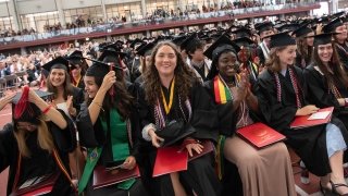 Several Saint Lawrence grads smile in anticipation of the turning of the tassles.