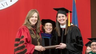 Kathryn Morris awards Gina Kingsbury and honorary degree.