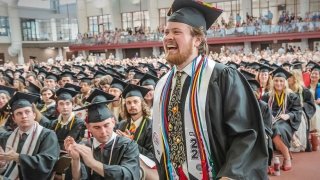 Boyd Leadership Prize Recipient Tyler Karasinski  Walking up to the stage to accept his award. Smiling and excited.