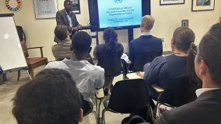 Group of students listening to a briefing in a classroom setting