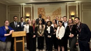 Laurentians Interning in New York City pose for a formal group photo.