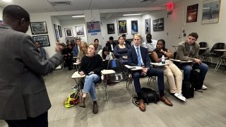 Group of students listening to a briefing in a classroom