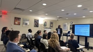 Group of students listening to a briefing in a classroom