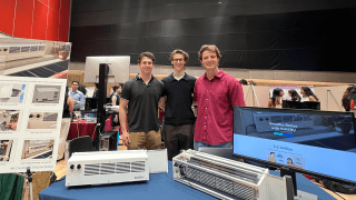 From left to right: Cole Ames '24, Nick Walker, and Austin Riesenberger '24 pictured with their SWERV energy recovery ventilator prototype