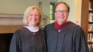 Krissie Bonin and Brad Rauch wearing graduation regalia. 