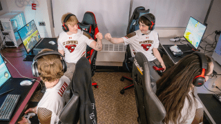 Saint Lawrence University esports athletes fist-bumping after a win