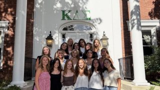 KDS members on the steps of their house