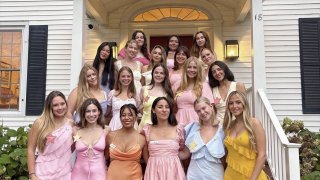 Chi Omega Members on front steps of their house