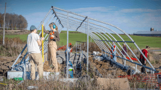 Students helping construct St. Lawrence University's greenhouse on the living laboratory