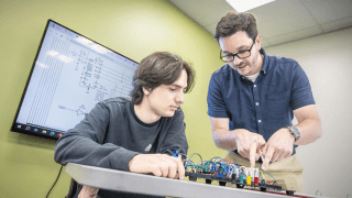 Assistant Professor of Computer Science Kevin Angstadt ’14 works with a student in the Cybersecurity lab.
